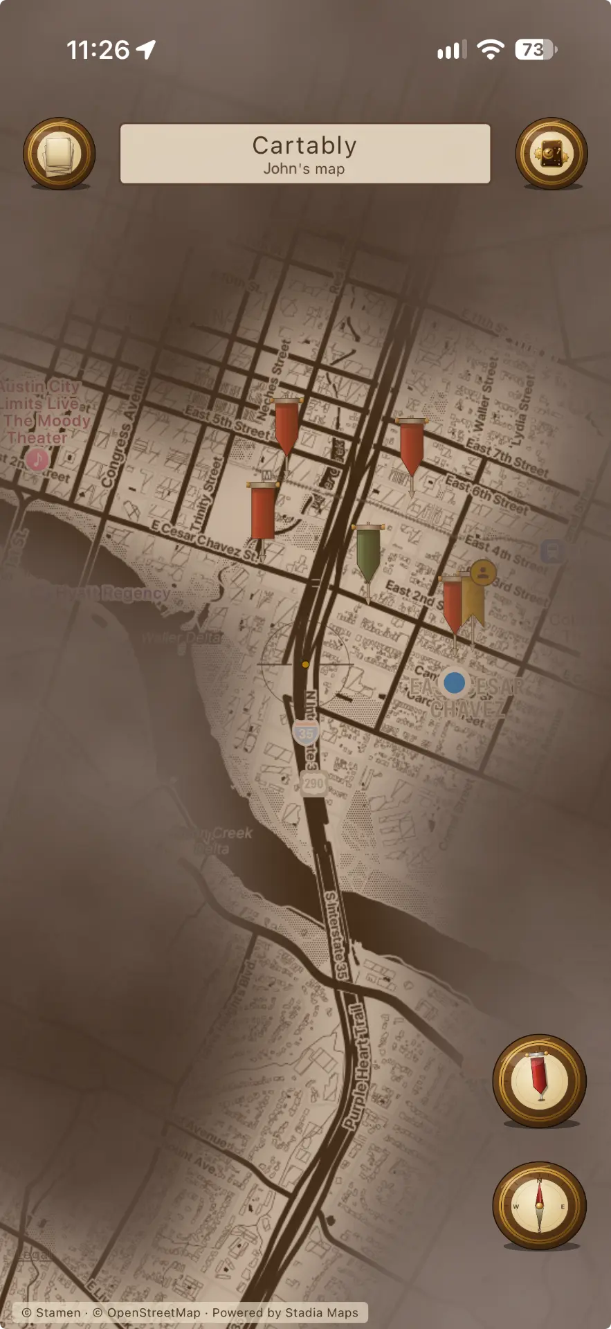 Cartably map view with a fog-of-war effect revealing explored streets and banner markers